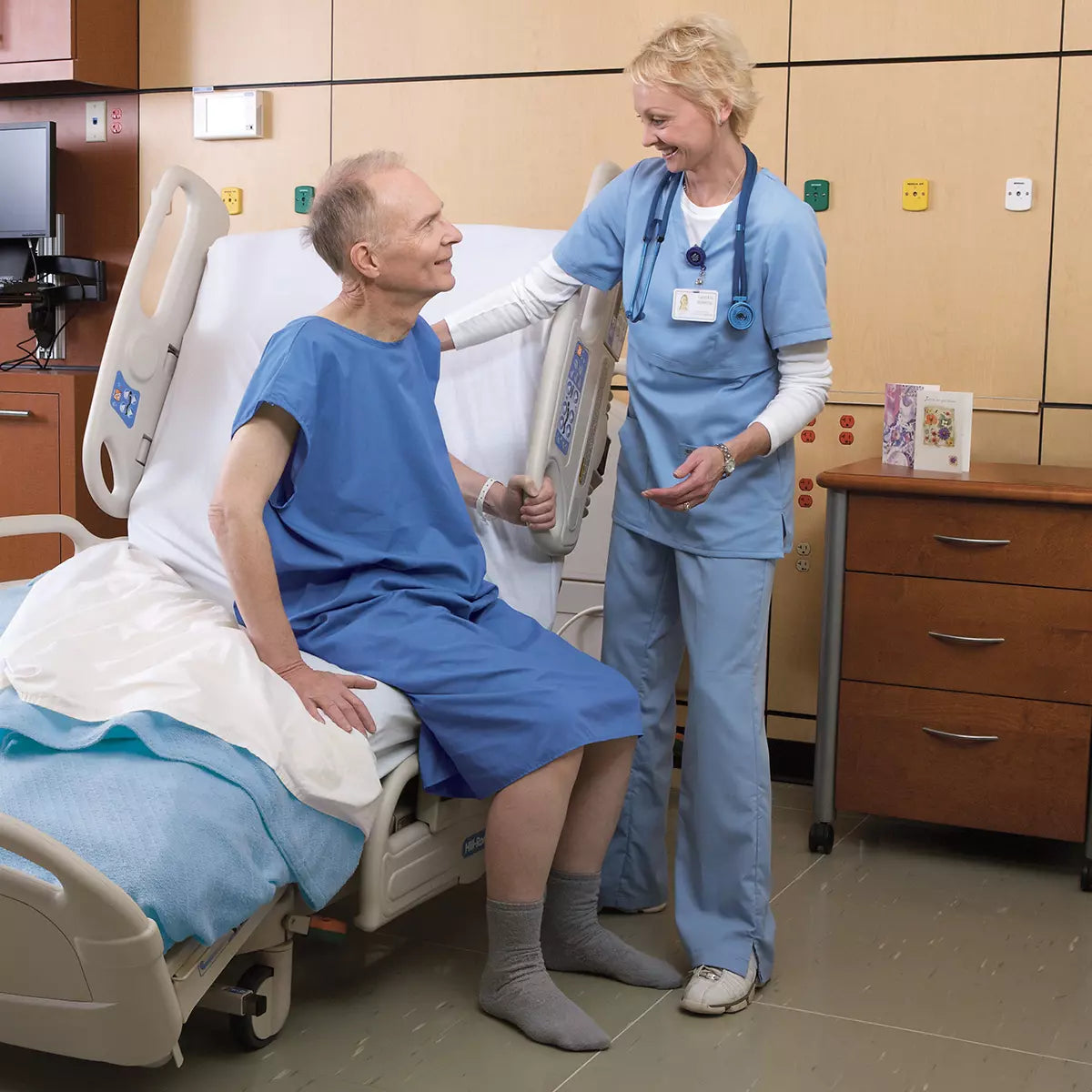 Male patient sitting upright in Hill-Rom VersaCare Bed